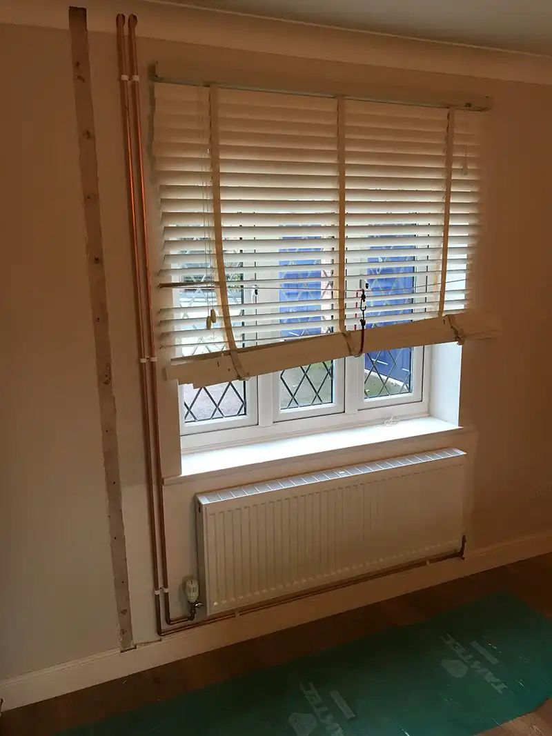 Radiator and pipework replacement with pipework hidden behind new curtains
