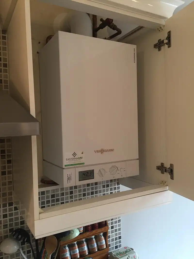 New regular boiler installed and hidden inside kitchen cupboard